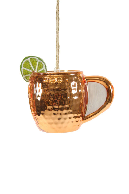 Copper mug with a lime wedge on a white background