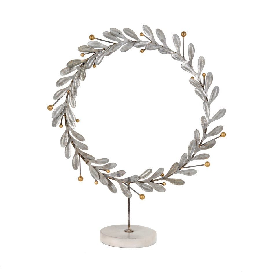 Silver And Gold Wreath on White Marble Stand